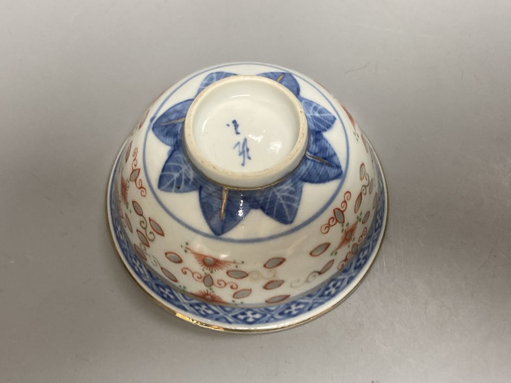 An 18th century English blue and white tea bowl and three smaller Chinese ceramic cups, two marks